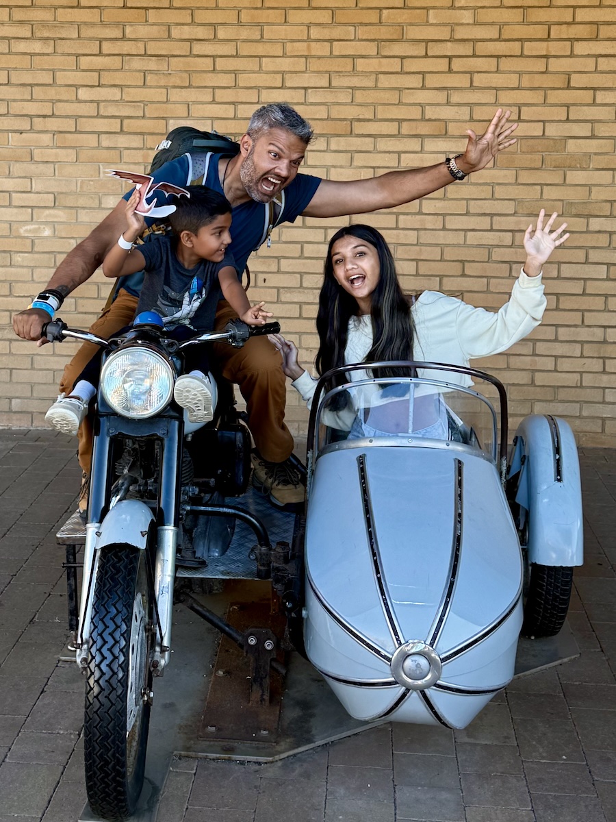 Family on vintage motorcycle with sidecar
